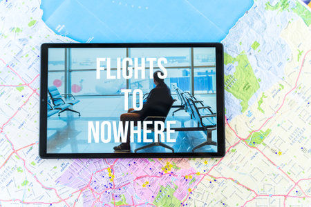 Online ordering, buying tickets in tablet for flight to nowhere. Special travel, round trip during   pandemic. Big city map.の写真素材