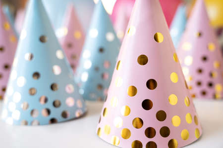 Many holiday caps for friends.Kids birthday party at home. Blue, pink polka dot hat. Family celebration. greetings. Decoration,gifts,bright balloons, flags.Remote virtual event for children,isolation.の写真素材