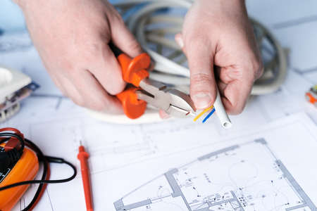 Man repairer making electricity project in house.Repairs planning.Drawing,diagrams,plan of...