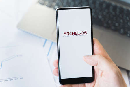 Russia Moscow 29.03.2021 Mobile phone with logo of Archegos Capital Management.Investment finance company,hedge fund.Margin call,bankruptcy,collapse,ruin.Loss of bank money.Falling stock market price.のeditorial素材