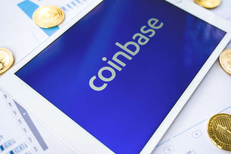 Russia Moscow 29.03.2021 Tablet with logo of cryptocurrency exchange Coinbase. Crypto coins company, service for buying, selling, trading, investing by market price. IPO start.Bitcoin,Ethereum,Ripple.のeditorial素材