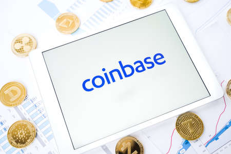 Russia Moscow 29.03.2021 Tablet with logo of cryptocurrency exchange Coinbase. Crypto coins company, service for buying, selling, trading, investing by market price. IPO start.Bitcoin,Ethereum,Ripple.のeditorial素材