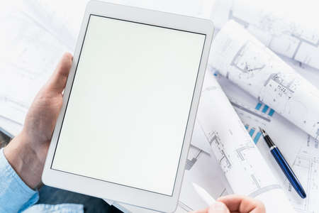 Working businessman investor.Blank tablet screen for mockup template.Financial...