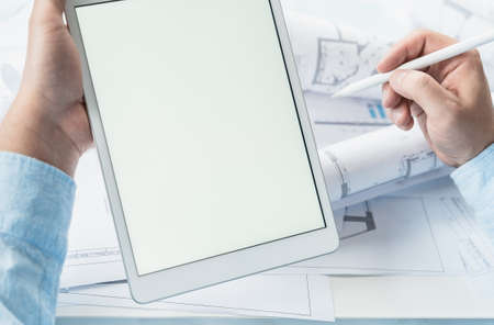Working businessman investor.Blank tablet screen for mockup template.Financial...