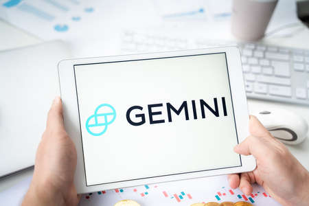 Russia Moscow 05/06/2021 Businessman with tablet.Logo of cryptocurrency stock exchange Gemini.Trading blockchain platform to buy, sell digital crypto coins, tokens Bitcoin, Ethereum.Business, investing.のeditorial素材