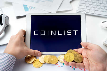 Russia Moscow 06.05.2021.Tablet, logo of Coinlist, platform with new blockchain cryptocurrency startup companies, projets, wallets, exchange stocks. Buy, store, send, swap crypto coins digital tokens.のeditorial素材