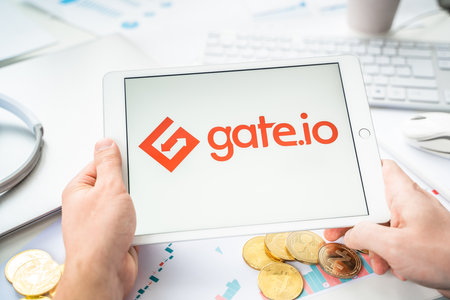 Russia Moscow 06.05.2021.Businessman with tablet.Logo of cryptocurrency stock exchange Gate.io.Trading blockchain platform to buy,sell digital crypto coins,tokens Bitcoin,Ethereum.Business,investing.のeditorial素材