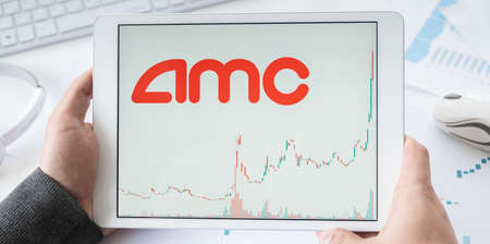 Russia Moscow 30.05.21 Tablet in hands with logo of AMC online cinemas network. Entertainment Holdings. Pumping stock exchange prices by Reddit investors.Playing on market, manipulation. Losses, crisis.のeditorial素材
