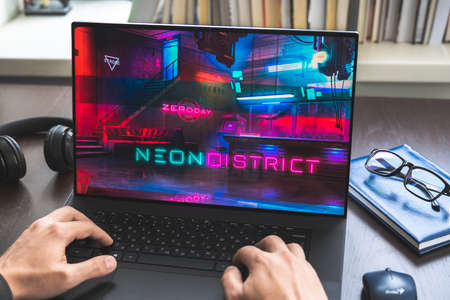 Russia Moscow 30.05.2021.Logo, screenshot of blockchain nft ethereum cryptocurrency kiber punk game Neon District in laptop screen. Man playing, collecting cards. Earning tokens, digital money at home.のeditorial素材