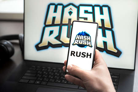 Russia Moscow 30.05.2021.Logo, screenshot of blockchain nft ethereum cryptocurrency game Hash Rush in laptop,mobile phone screen. Man playing,mining crypto coins Rush. Earning money with Lands,heroes.のeditorial素材
