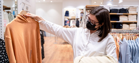 Personal private shopping tour with stylist.Professional individual assistance for client, shopper, woman in store.Choosing, buying stylish fashion clothes for trendy look.Sale in mall, boutique, showroom.の写真素材