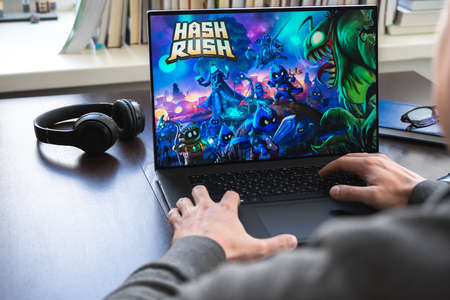 Russia Moscow 30.05.2021.Logo, screenshot of blockchain nft ethereum cryptocurrency game Hash Rush in laptop screen. Man playing,mining crypto coins Rush. Earning digital money at home. Lands, heroes.のeditorial素材