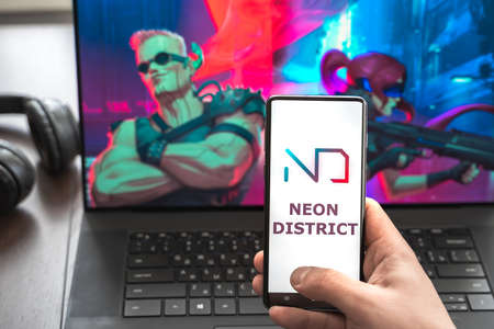Russia Moscow 30.05.2021.Logo,screenshot of blockchain nft ethereum cryptocurrency kiber punk game Neon District in laptop, mobile phone. Man playing, collecting cards. Earning tokens,digital money.のeditorial素材