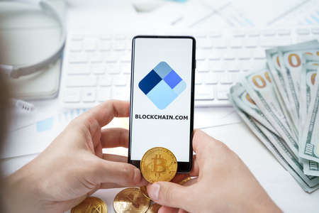 Russia Moscow 20.05.2021 Blockchain.com logo in mobile phone.Cryptocurrency decentralized exchange...