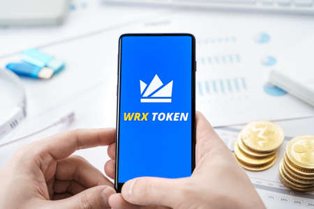 Russia Moscow 20.05.2021 WRX token logo in mobile phone.WazirX cryptocurrency decentralized exchange DEX.Trading blockchain platform.Swap,buy,sell crypto token,digital coin Bitcoin,Ethereum.Business.のeditorial素材