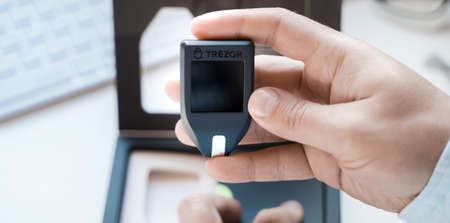 Russia Moscow 12.06.2021 Unpacking of box Trezor hardware,software pocket wallet.Accessory kit,password sheet.Safe,secure vault of cryptocurrency,coins,tokens,nft digital assets.Storage for login,key.のeditorial素材