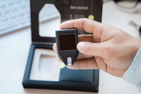Russia Moscow 12.06.2021 Unpacking of box Trezor hardware,software pocket wallet.Accessory...