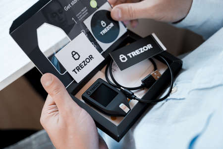 Russia Moscow 12.06.2021 Unpacking of box Trezor hardware,software pocket wallet.Accessory...