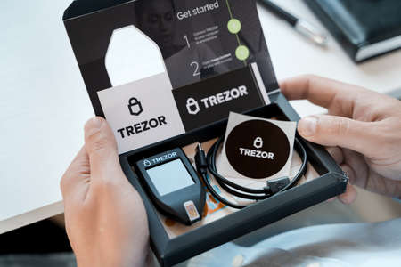 Russia Moscow 12.06.2021 Unpacking of box Trezor hardware,software pocket wallet.Accessory kit,password sheet.Safe,secure vault of cryptocurrency,coins,tokens,nft digital assets.Storage for login,key.のeditorial素材