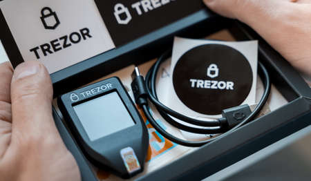 Russia Moscow 12.06.2021 Unpacking of box Trezor hardware,software pocket wallet.Accessory...