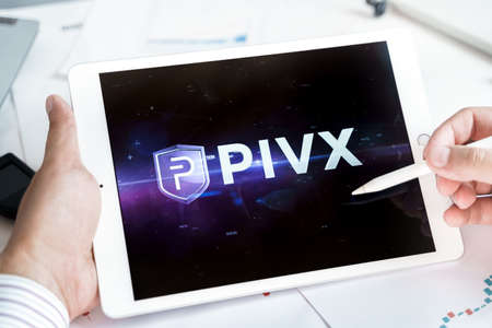 Moscow Russia 20.07.2021 Logo of PIVX coin in mobile phone. Cryptocurrency PVX token. Trading blockchain platform to buy,sell on decentralized exchange DEX. Digital money.Business,investing.のeditorial素材
