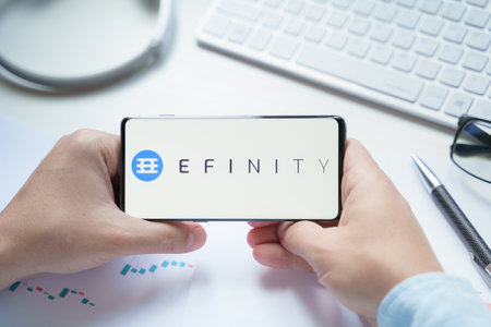 Russia, Moscow 08.06.2021. Mobile phone with logo of Efinity, EFI token. Next-generation Blockchain for NFTs. Scalable, decentralized, cross-chain network designed to bring non-fungible tokens.のeditorial素材