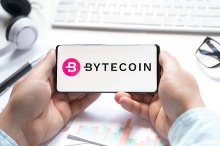 Russia Moscow 08.06.2021 Logo of Bytecoin coin in mobile phone. Cryptocurrency token. Trading blockchain platform to buy,sell on decentralized exchange DEX. Digital money.Business,investing.のeditorial素材