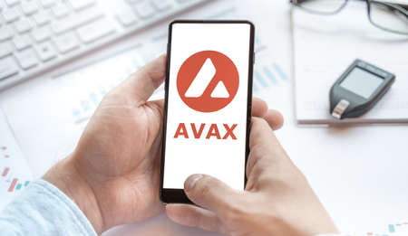 Logo of Avalanche coin in tablet. Cryptocurrency AVAX token. Trading blockchain platform to buy,sell on decentralized exchange DEX,DEFI. Digital money.Business,investing.のeditorial素材