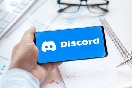 Logo of Discord group chatting application, page in mobile phone. Social net, media resource, platfom, app to talk, chat, voice, hang out. Using for family, work, business, news, information.のeditorial素材