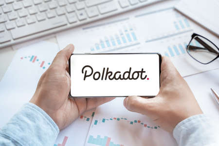 Logo of Polkadot coin in tablet. Cryptocurrency DOT token. Trading blockchain platform to buy,sell on decentralized exchange DEX,DEFI. Digital money.Business,investing.のeditorial素材
