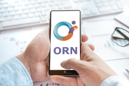 Logo of Orion Protocol in tablet. Cryptocurrency coin ORN token. Trading blockchain platform to buy,sell on decentralized exchange DEX,DEFI. Digital money.Business,investing.のeditorial素材