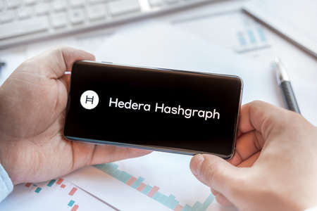 Logo of Hedera Hashgraph in tablet. Cryptocurrency HBAR coin token. Trading blockchain platform to buy,sell on decentralized exchange DEX,DEFI. Digital money.Business,investing.のeditorial素材