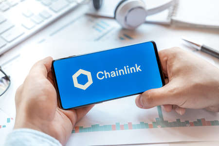 Logo of Chainlink coin in tablet. Cryptocurrency Link token. Trading blockchain platform to buy,sell...