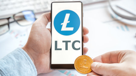 Logo of Litecoin coin in tablet. Cryptocurrency LTC token. Trading blockchain platform to buy,sell on decentralized exchange DEX,DEFI. Digital money.Business,investing.のeditorial素材