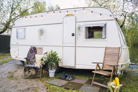 Family traveling in camper,house on wheels,trailer,motor home. Romantic road travel,freedom life.Campsite overnight, parking in van.Wanderlust vacation,weekend. Happy adventure.Relax area with chairs.の写真素材