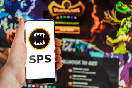 Russia Moscow 04.09.2021.Logo,screenshot of Splinterlands, SPS token.Blockchain nft ethereum cryptocurrency game in laptop,mobile phone.Man playing with crypto coins.Earning digital money.Land,hero.のeditorial素材