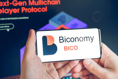 Moscow Russia 25.12.2021 Logo of Biconomy coin in mobile phone. Cryptocurrency BICO token. Trading blockchain platform to buy, sell on decentralized exchange DEX. Digital money.Business,investing.のeditorial素材