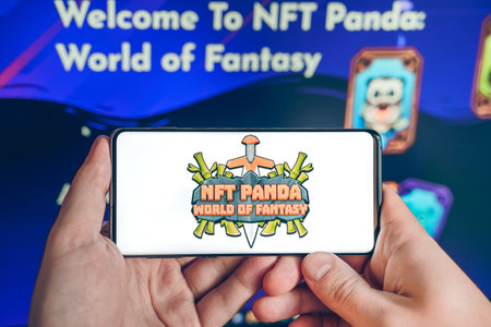 Russia Moscow 25.12.2021 Logo of NFT Panda:World of Fantasy. Blockchain ethereum cryptocurrency strategy game in laptop,mobile phone.Man playing crypto coin,token. Earning digital money. Play-to-earn.のeditorial素材