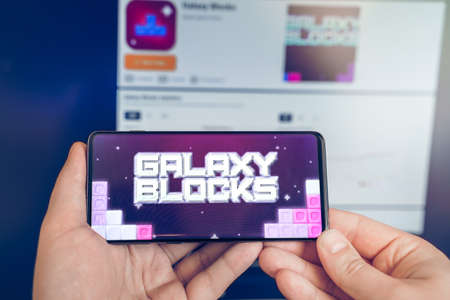 Russia Moscow 19.01.2022 Logo of Galaxy Blocks. Token,blockchain nft ethereum cryptocurrency strategy game in laptop,mobile phone.Man playing for crypto coin.Earning digital money.Play-to-earn land.のeditorial素材