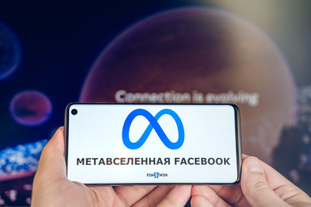 Russia Moscow 19.01.2022 Logo of Meta, Facebook metaverse. Investing in digital universe. Buy land in virtual world. Blockchain nft cryptocurrency.Man with mobile phone.Play-to-earn.Buing accessories.のeditorial素材