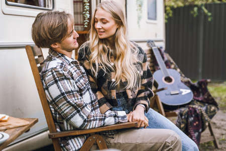 Young just married couple traveling in camper,house on wheels,trailer,motor home.Love romantic road travel,freedom life.Campsite overnight in van.Wanderlust vacation,weekend. girl,guy,happy adventure.の写真素材