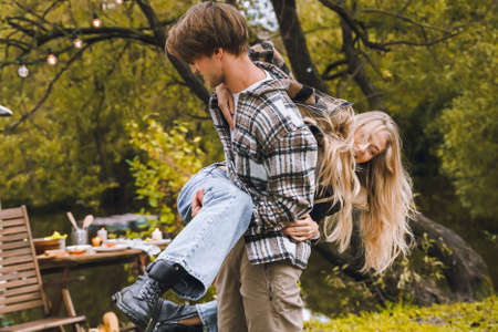 Young just married couple traveling in camper,house on wheels,trailer,motor home.Love romantic road travel,freedom life.Campsite overnight in van.Wanderlust vacation,weekend. girl,guy,happy adventure.の写真素材