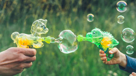 Pony, dinosaur soap bubble gun shooter, blower. Battle, party for kids. Girls,chidren playing funny...