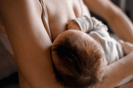 Mom, mummy, young mother with little baby daughter. breastfeeding. Mum feeding child with breast milk.Newborn cute happy girl smiling in woman hands.Family happiness.Age parents,parenting,motherhood.の写真素材