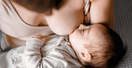 Mom, mummy, young mother with little baby daughter. breastfeeding. Mum feeding child with breast milk.Newborn cute happy girl smiling in woman hands.Family happiness.Age parents,parenting,motherhood.の写真素材