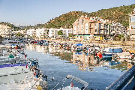Turkey, Marmaris 24.12.2022 Motor and sail boats, yachts, launch in the water marina, dock, channel in the sunny sea port of the picturesque old city of Marmaris in Turkey.のeditorial素材