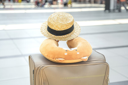 Suitcase,bag in airport terminal.Funny travel head neck airplane pillow.Boarding to flight.Happy family vacation travel.Luggage baggage check in arrival departure hall.Summer sea journey.Holiday trip.の写真素材