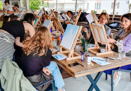 Turkey Marmaris 01.04.2023 Painting masterclass. Art party in restaurant. glass of wine. Aquarelle watercolor, acrylic paints. beginner class. Seascape nautical marine theme, sea boats, ships sails.のeditorial素材