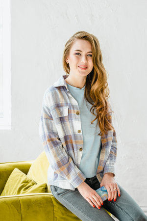Young beautiful long haired college student girl in casual shirt with mobile cell phone.Businesswoman calling,speaking.Typing love message,chat,date in social network with boyfriend.Business planning.の写真素材