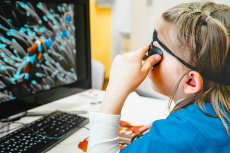 Little girl in medical office undergoing advanced laser vision treatment, correction for eyes health. Pediatric ophthalmology procedure. Visual acuity, strabismus improvement. Advanced technology.の写真素材